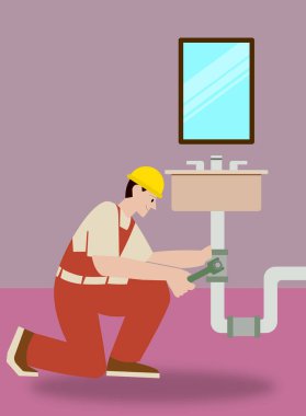 Male plumber fixing a bathroom sink, wearing a safety helmet