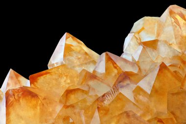 Citrine stone macro crystalls. Yellow quartz on black background clipart