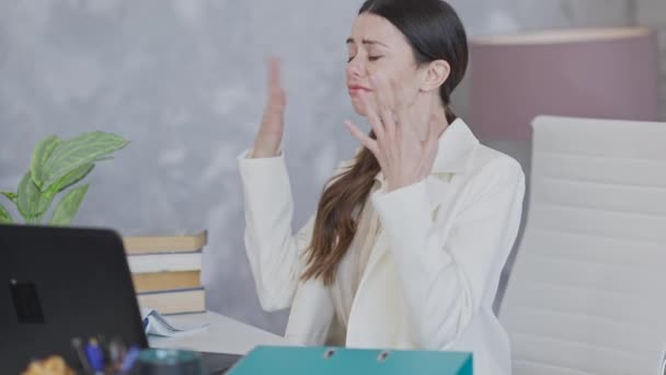 Overwhelmed crying young woman sitting in office trying to calm down. Portrait of stressed hopeless beautiful Caucasian female employee having business troubles. Exhaustion and overworking. — Stock Video