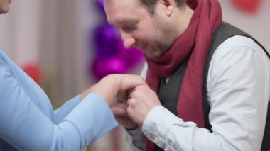 Sevgili koca erkek arkadaşın, tanınmayan karısının elini öpüp gülümseyen sevgilisinin yakın plan görüntüsü. Sevgililer Günü 'nde kadınlara duygularını ifade eden mutlu beyaz bir adam..