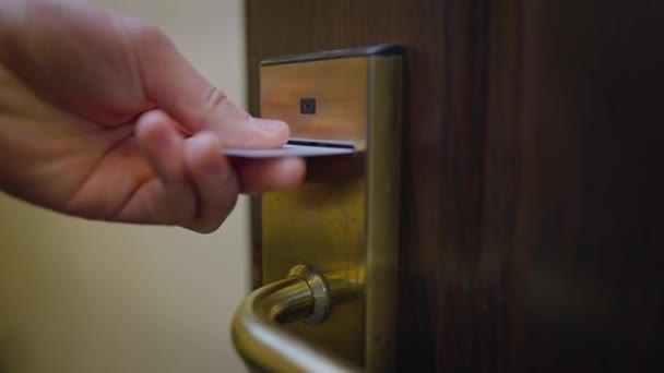 Close-up mannelijke hand openen hotelkamer deur met kaart. Onherkenbare mannelijke toerist binnen in luxe accommodaties. Langzame beweging. — Stockvideo