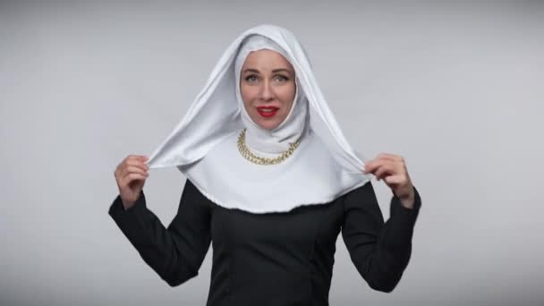 Cheerful dance of joyful smiling Caucasian woman in nun costume at grey background. Portrait of carefree slim beautiful lady dancing having fun. Joy and lifestyle concept. — Stock Video