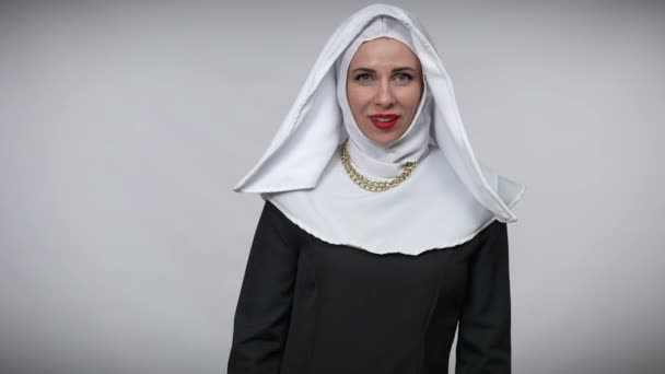 Joyful carefree woman in nun costume having fun at grey background stretching hands aside smiling looking at camera. Cheerful relaxed Caucasian lady posing. Happiness and joy concept. — Stock Video