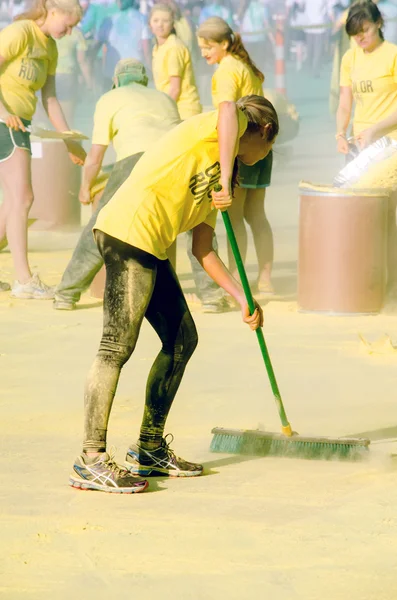 Workers cleaning up yellow powder — Stock Photo, Image