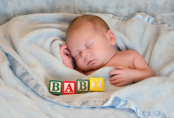Sleeping portrait of a baby, with blocks — Stock Photo, Image