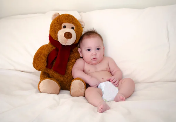 Teddy bear and serious baby boy — Stock Photo, Image