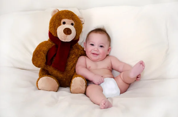 Teddy bear and happy baby boy — Stock Photo, Image
