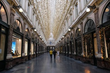 30 Kasım 2020 'de Brüksel, Belçika' da Noel için dekore edilmiş vitrinlere bakan yüz maskesi takan insanlar.