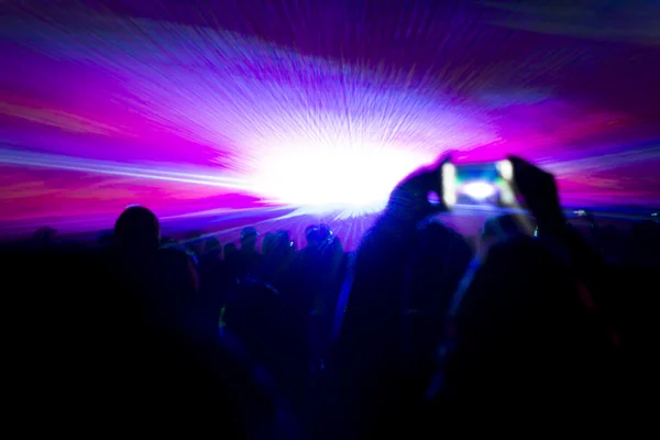 Laser show party rays in front of smartphone filming video — Stock Photo, Image