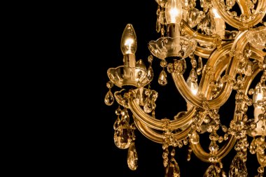 Gallant chandelier with light candles and dark side background clipart