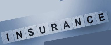 INSURANCE mesaj sözcüğü ahşap bir masada gökyüzü mavi eğimli arkaplanda küp bloklar üzerinde. Sağlık, araba, gayrimenkul sigortası konsepti.