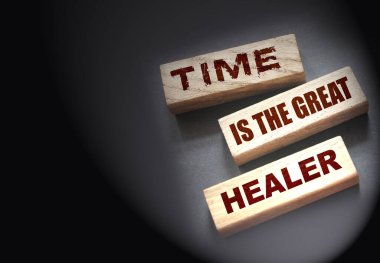 Time is the best healer words on wooden blocks. End of relationship and soul pain concept. clipart