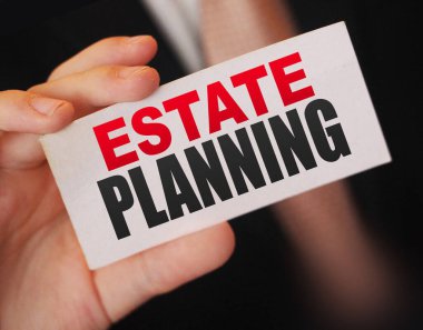 Bir iş adamının kartındaki gayrimenkul planlama kelimeleri. Emlak işi kavramı.