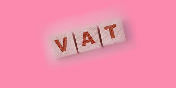 Vat on wooden cubes over blur background with copy spcae, financial value added tax concept background.
