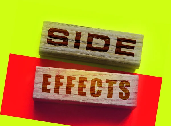 SIDE EFFECTs on wooden blocks. Pharmaceutical medical drugs Concept.
