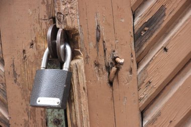 Hanging lock on ancient vintage door. locked old wooden door. 
