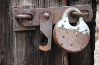 Hanging lock on ancient vintage door. locked old wooden door. 