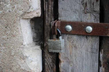 Hanging lock on ancient vintage door. locked old wooden door. 