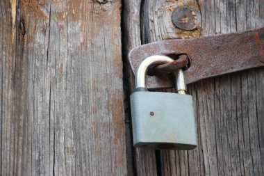 Hanging lock on ancient vintage door. locked old wooden door. 