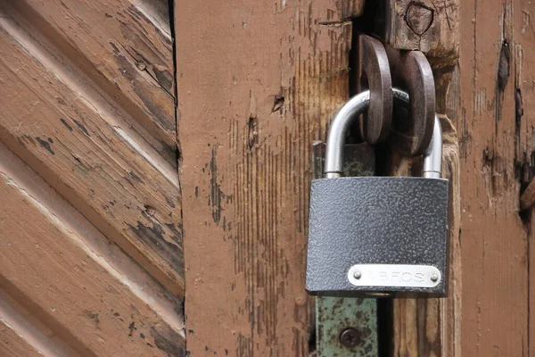 Hanging lock on ancient vintage door. locked old wooden door.