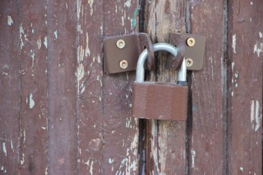 Hanging lock on ancient vintage door. locked old wooden door. 