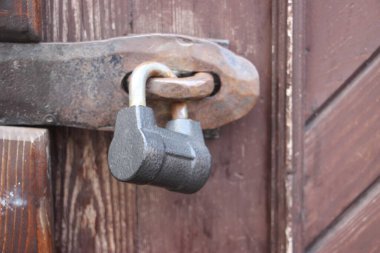 Hanging lock on ancient vintage door. locked old wooden door. 