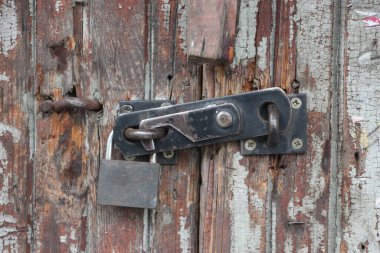 Hanging lock on ancient vintage door. locked old wooden door. 
