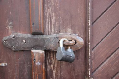 Hanging lock on ancient vintage door. locked old wooden door. 
