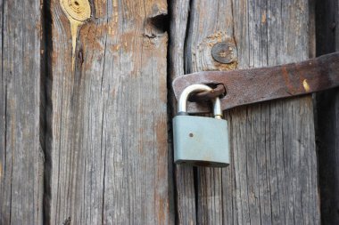 Hanging lock on ancient vintage door. locked old wooden door. 