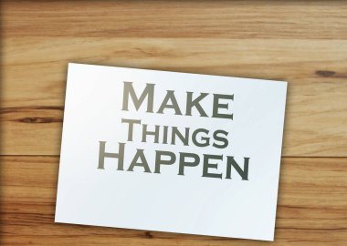 make things happen words on page around on wooden table. Financial business concept.