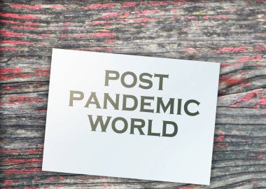 Post-pandemic world text on page around on grunge wooden background. Healthcare quarantine Concept.