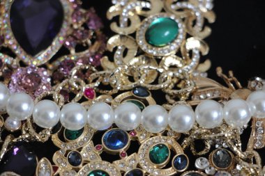 Zümrüt değerli taşlı klasik broşürler. Farklı renklerde cam ve metal broşlar. Renkli ve moda broşları. Lüks bir geçmişi var. Seçici odak