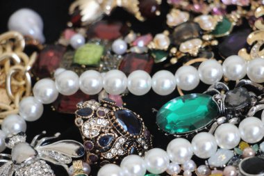 Zümrüt değerli taşlı klasik broşürler. Farklı renklerde cam ve metal broşlar. Renkli ve moda broşları. Lüks bir geçmişi var. Seçici odak