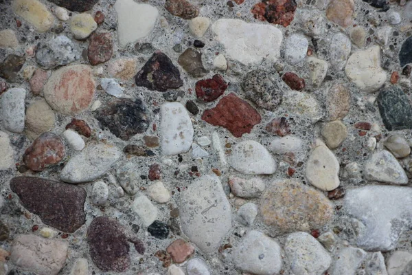 pebbles close up view, grey natural irregular stones texture industrial style background