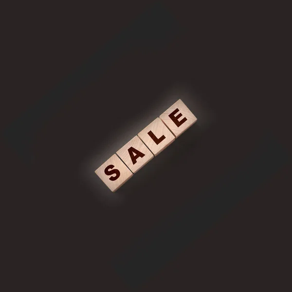 The word sale on wooden cubes on a black background. — Stock Photo, Image