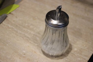 Tahta bir masada bir bardak tuz ve biber.