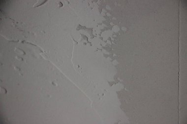 İnce desenli ve çizikli desenli gri duvara yakın çekim.