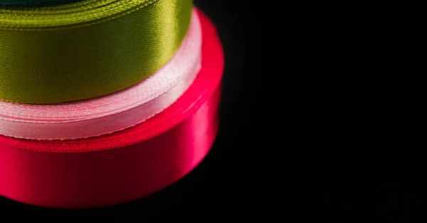 Satin Ribbons Coils Stacked Black Background Shiny Ribbons Green Pink — Stock Photo, Image