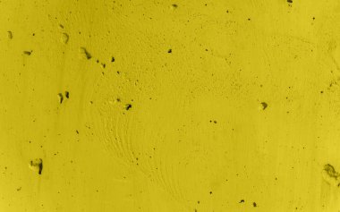 Beton bir duvar dokusu. Sarı rengin pürüzlü ve pürüzlü yüzeyi. İnşaat arka planı. Arka plan 2021 renginde boyanmış..