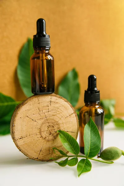 Two Glass Bottles Walnut Oil Piece Wood Cosmetic Medical Product — Stock Photo, Image