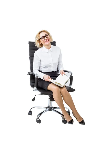 A beautiful smiling businesswoman with a book sitting on the castor chair. — Stock Photo, Image