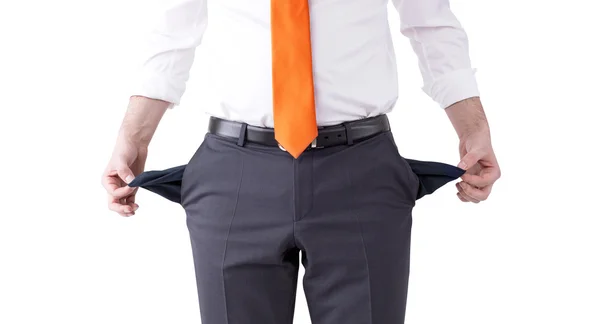 Un hombre de negocios con una corbata naranja girando sus bolsillos vacíos al revés. Vista frontal, sin cabeza. Aislado. Concepto de quiebra . — Foto de Stock