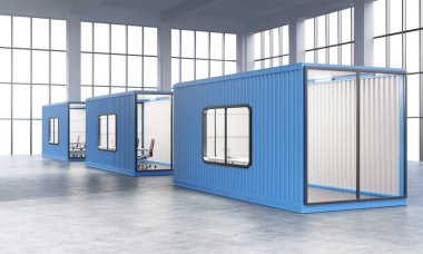 Three blue sea containers with offices inside.