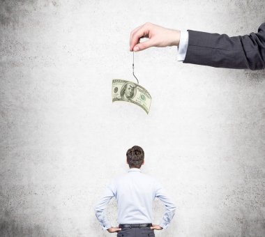 A hand holding a one-hundred dollar banknote on a thread, a businessman with hands on hips looking at it.