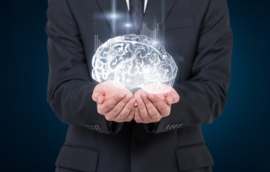 Man as if holding shining image of brain in hands, graphs from it.