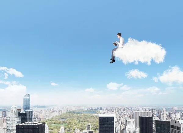Man on a cloud reading a book — Stock Photo, Image