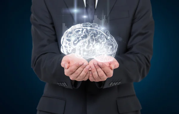 Man as if holding shining image of brain in hands, graphs from it. — Stockfoto