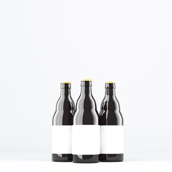 Tres botellas de cerveza con etiquetas blancas. Vidrio oscuro . —  Fotos de Stock