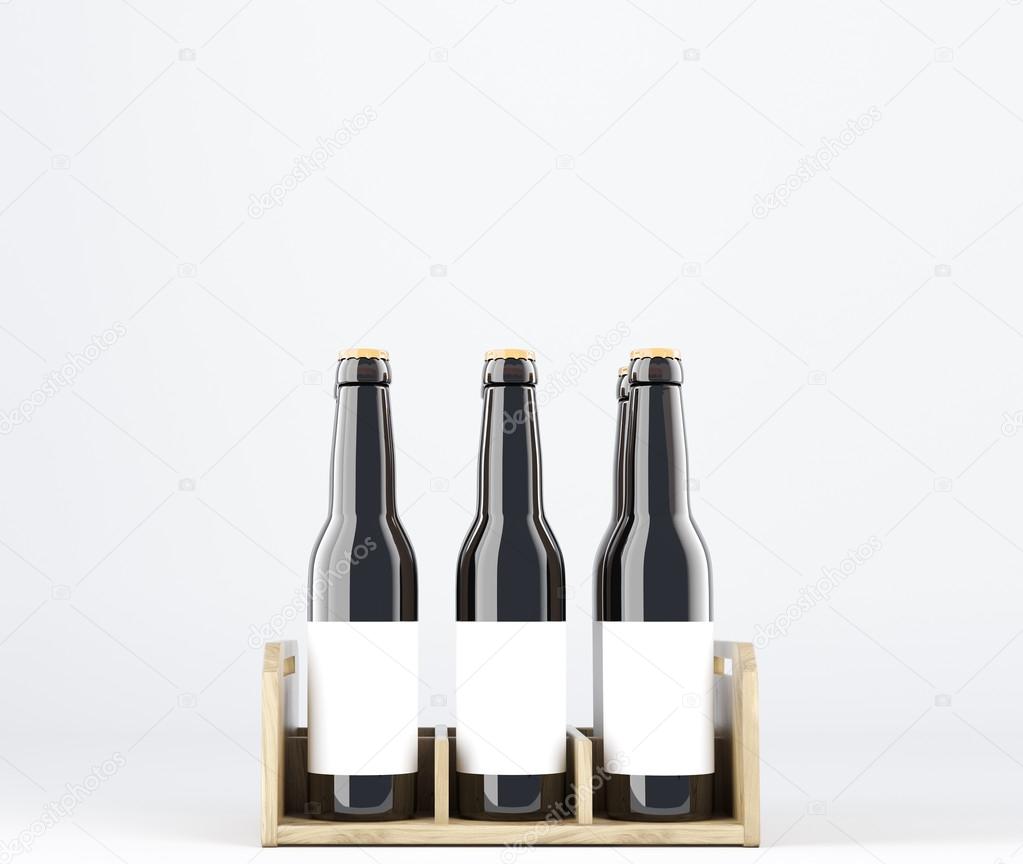Six wine bottles with blank labels in wooden box.