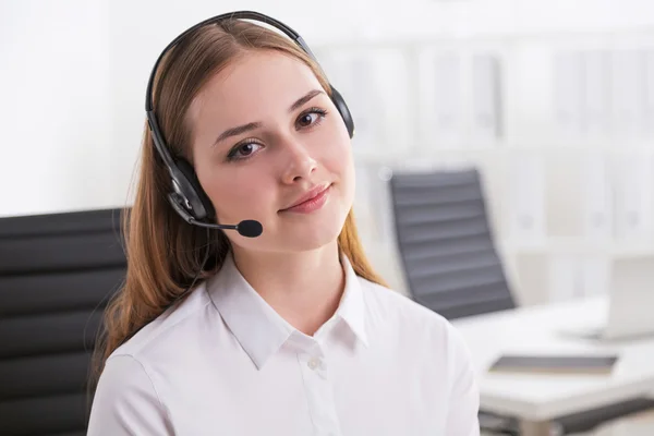 Young businesswoman in headphones with microphone. — Stockfoto